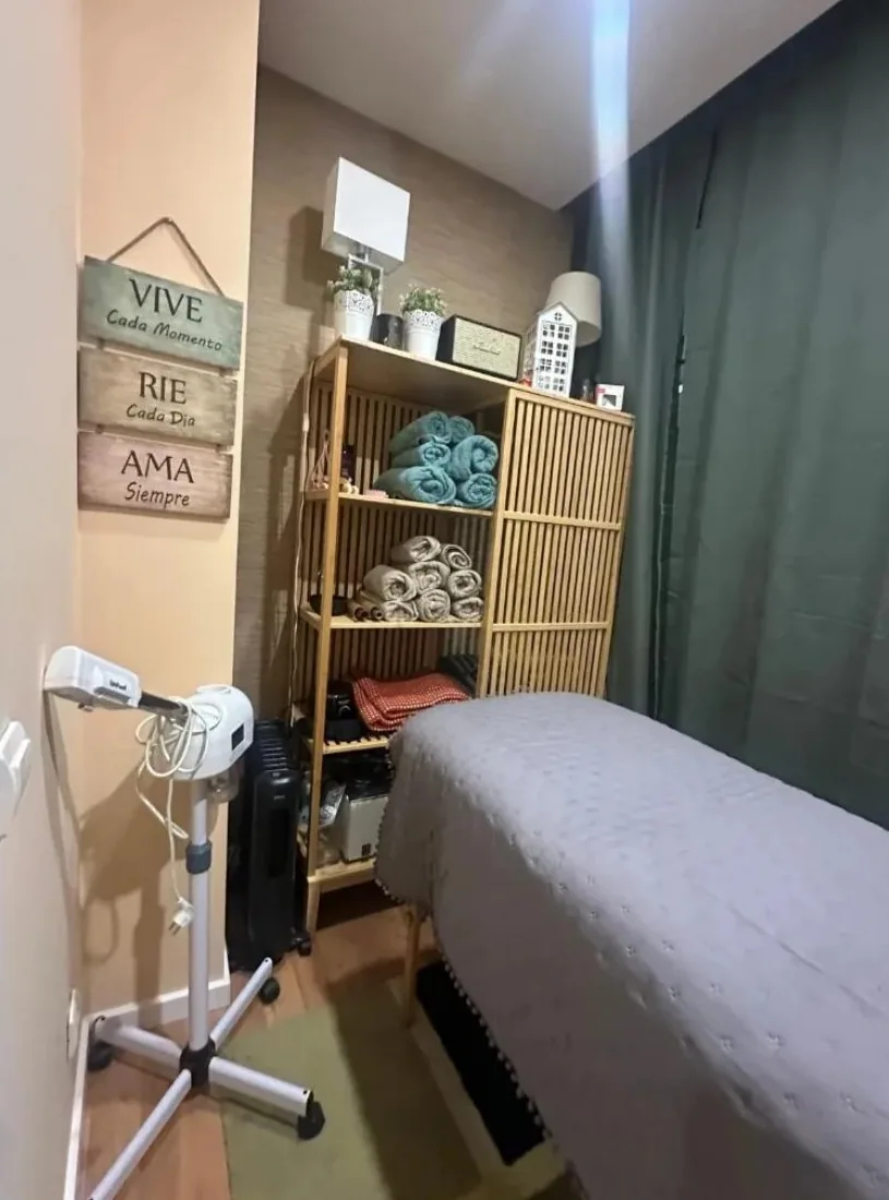 Treatment room with the table made up and the towels neatly folded