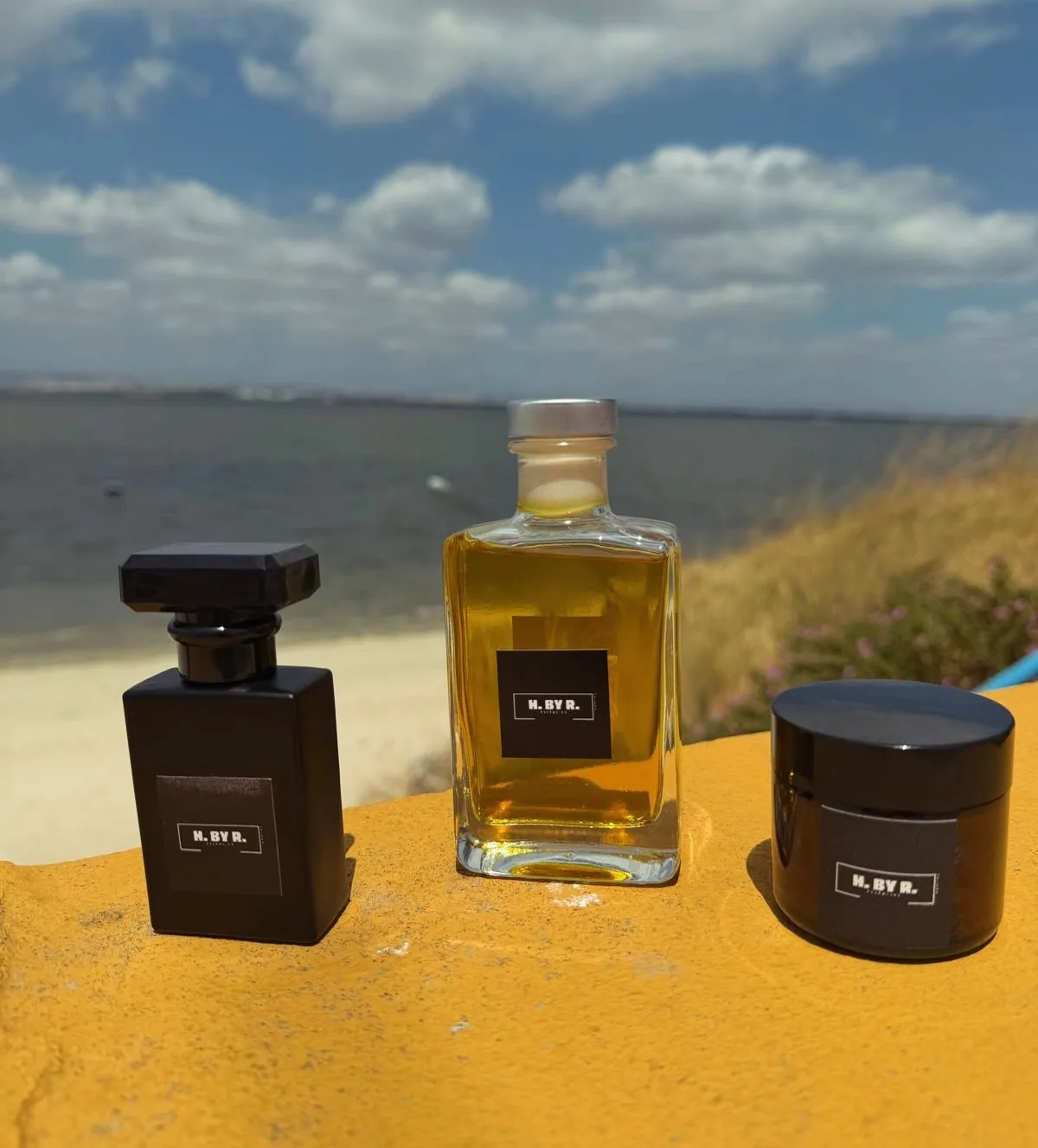 The three formats in the H.By.R range: perfume bottle, essence and cream